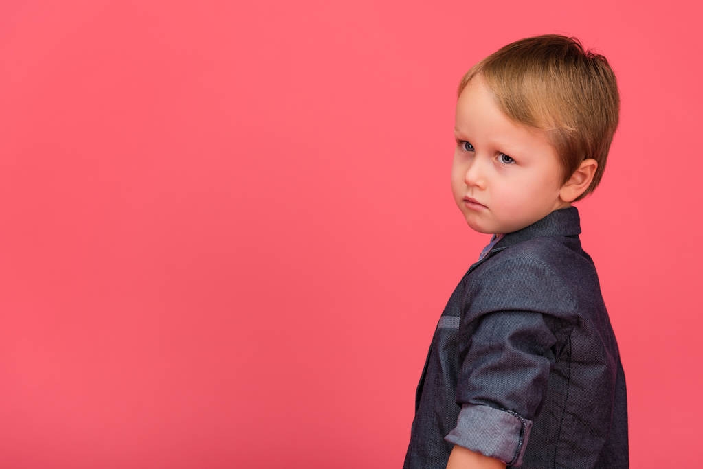side view of adorable little boy isolated on pink - Photo, Image