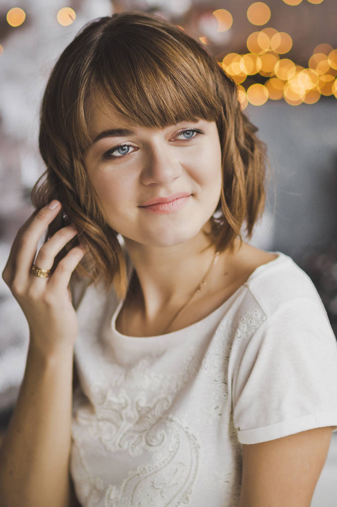 Portrait of a girl with beautiful bokeh from the Christmas light - Photo, Image