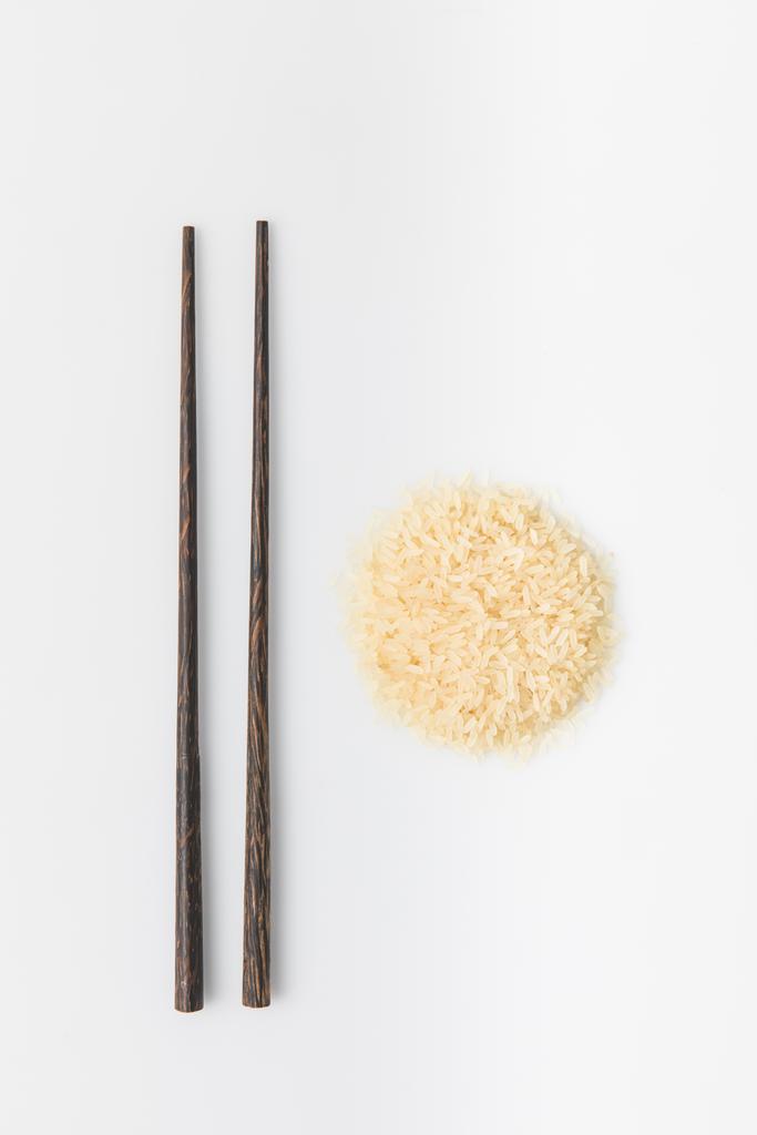 heap of rice with chopsticks isolated on white - Photo, Image