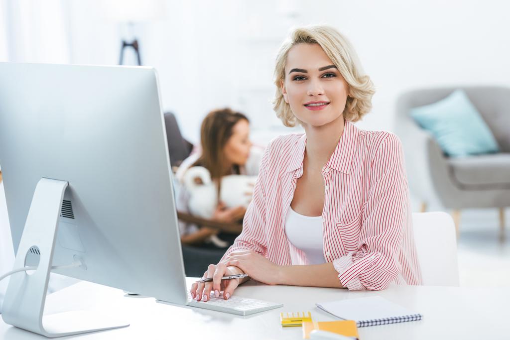 beautiful blonde girl working with computer at home - Photo, Image