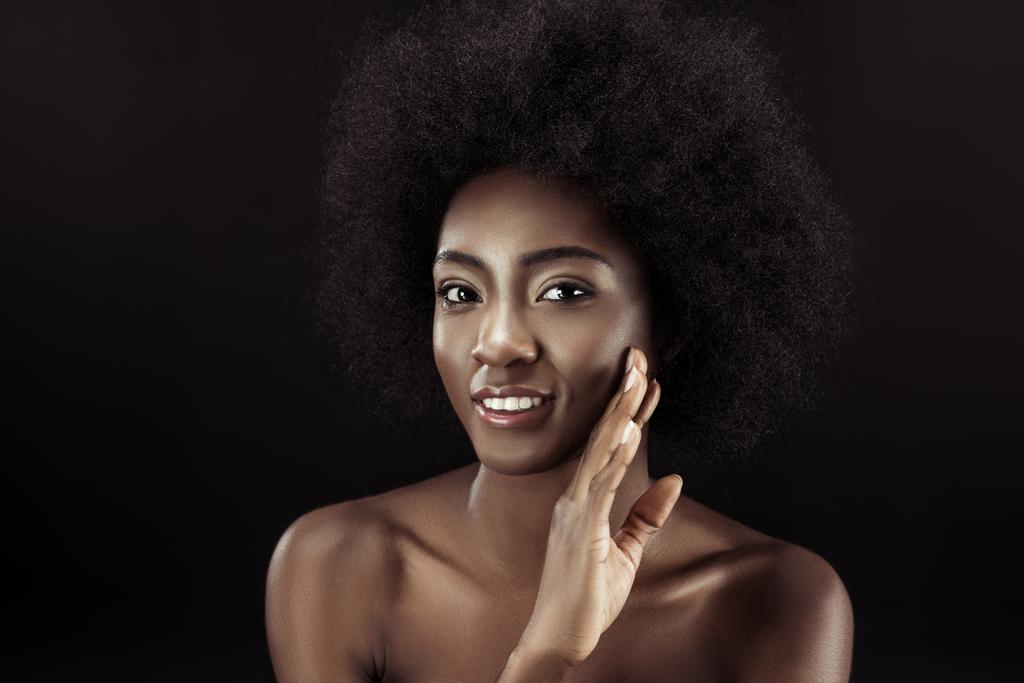 kaunis afrikkalainen amerikkalainen nainen koskettaa hänen kasvonsa eristetty musta
 - Valokuva, kuva