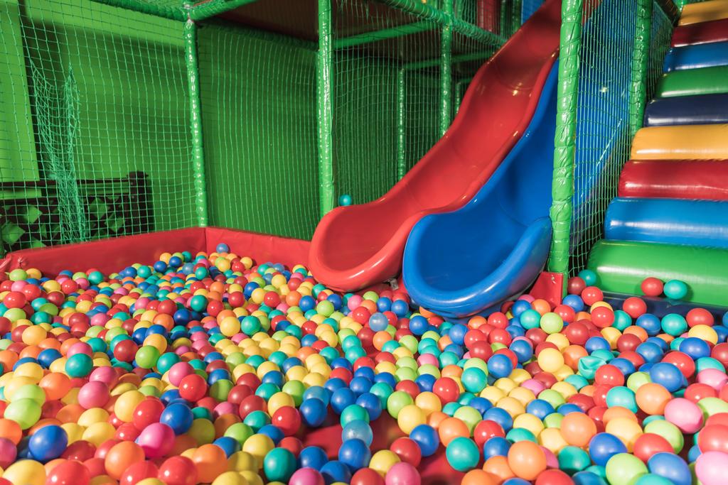 slides and pool with colorful balls in entertainment center - Photo, Image