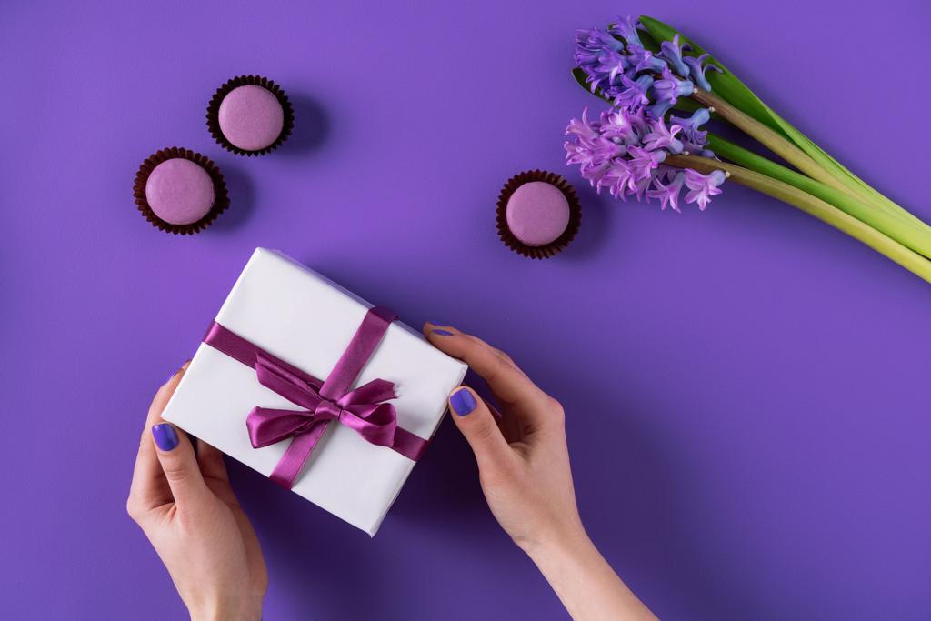 cropped image of girl holding present box on purple - Photo, Image