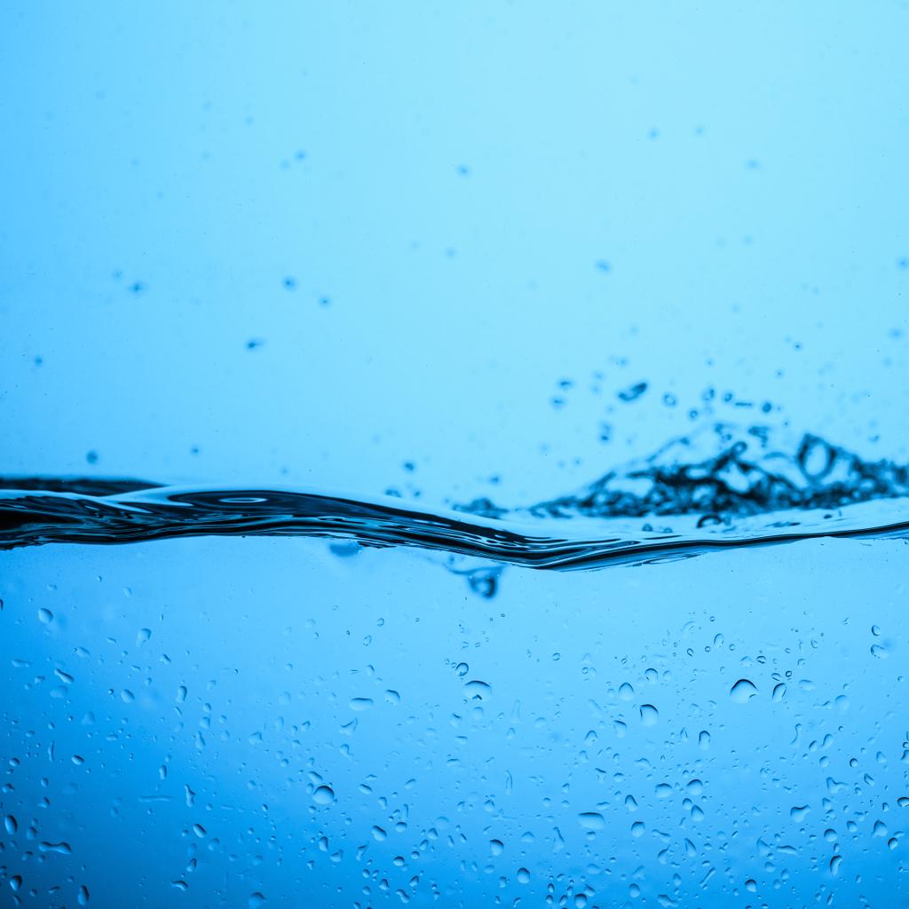 flowing water background with bubbles and drops, isolated on blue - Photo, Image