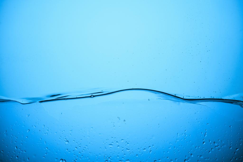 pure water texture with drops, isolated on blue - Photo, Image