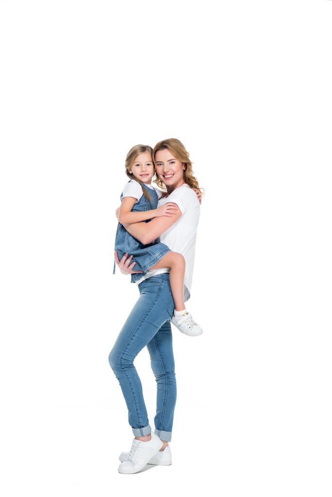 smiling mother holding happy daughter on hands, isolated on white - Photo, Image