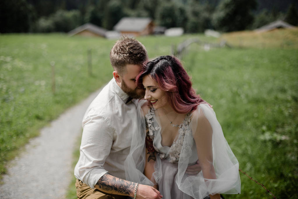 beautiful young bride and groom hugging and laughing in mountain valley, Alps - Photo, Image