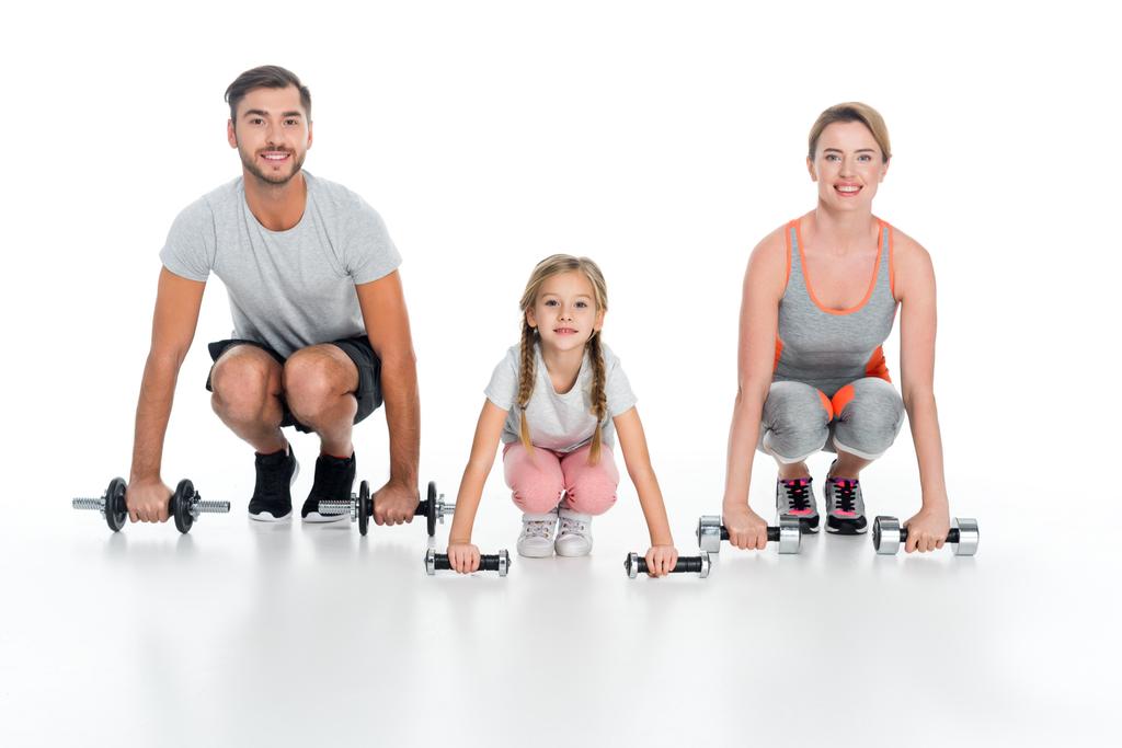 sportive parents and daughter with dumbbells isolated on white - Photo, Image