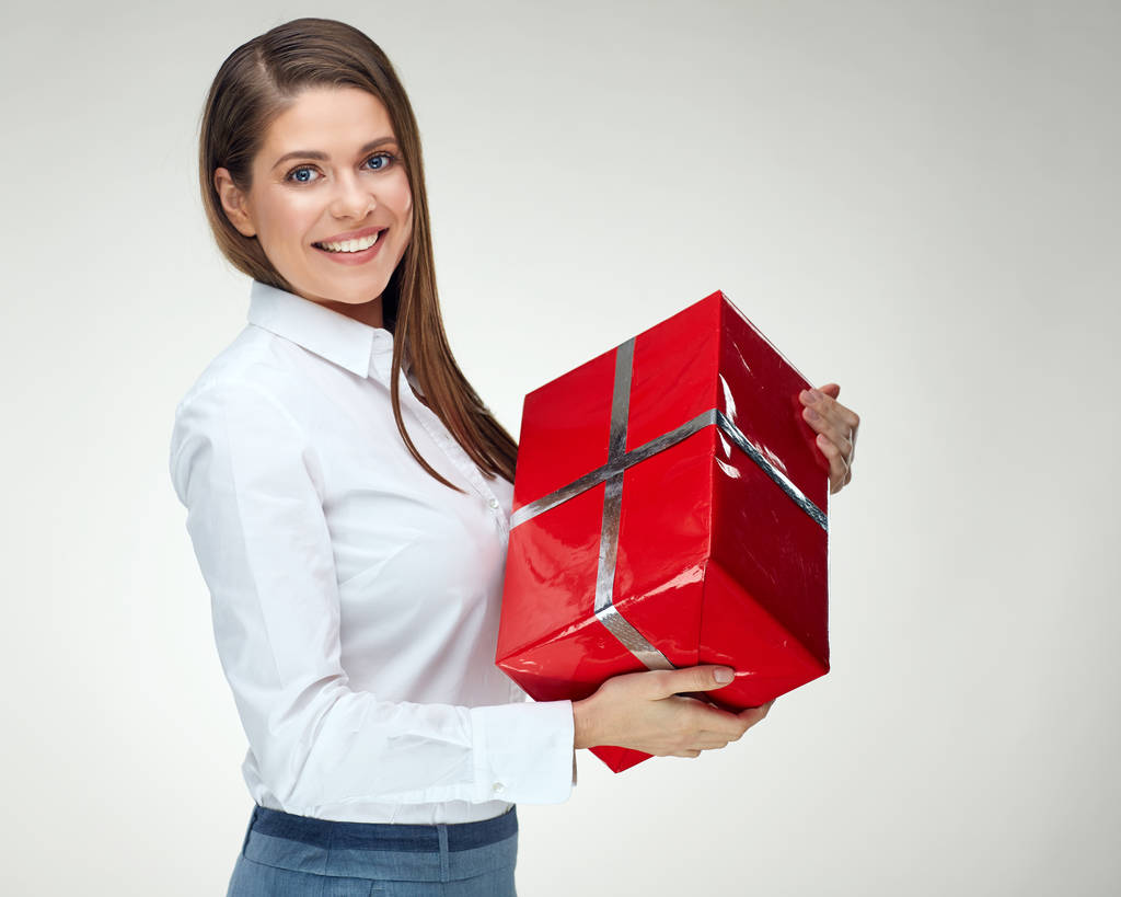 Happy businesswoman in shirt holding paper red gift box  - Photo, Image