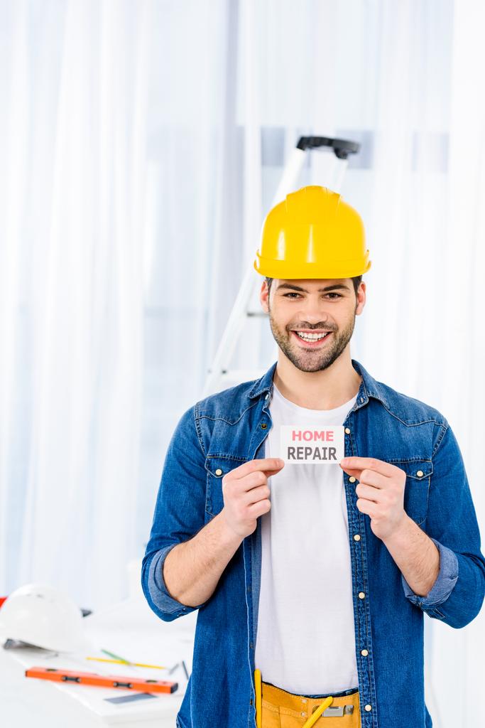 smiling handsome man holding home repair card   - Photo, Image