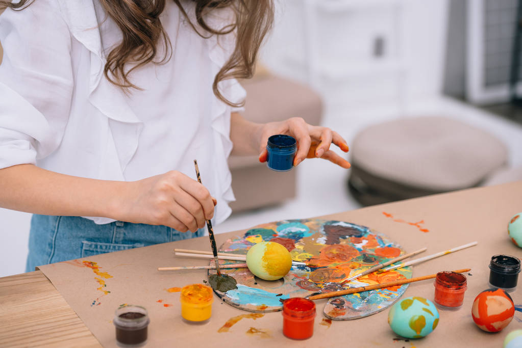 cropped shot of little child painting easter eggs - Photo, Image