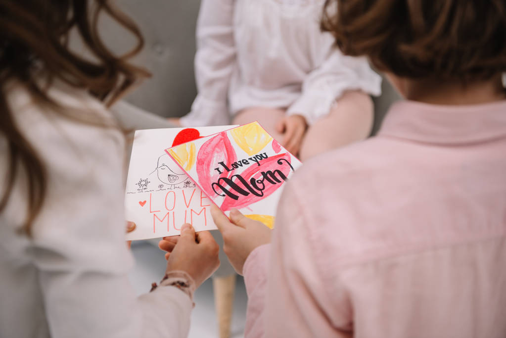 recortado tiro de niños presentando madres día tarjeta de felicitación para la madre
 - Foto, Imagen
