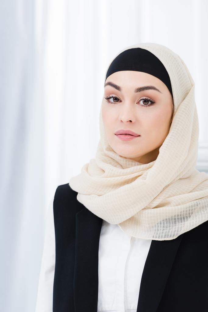 portrét krásné obchodnice v hidžábu při pohledu na fotoaparát - Fotografie, Obrázek