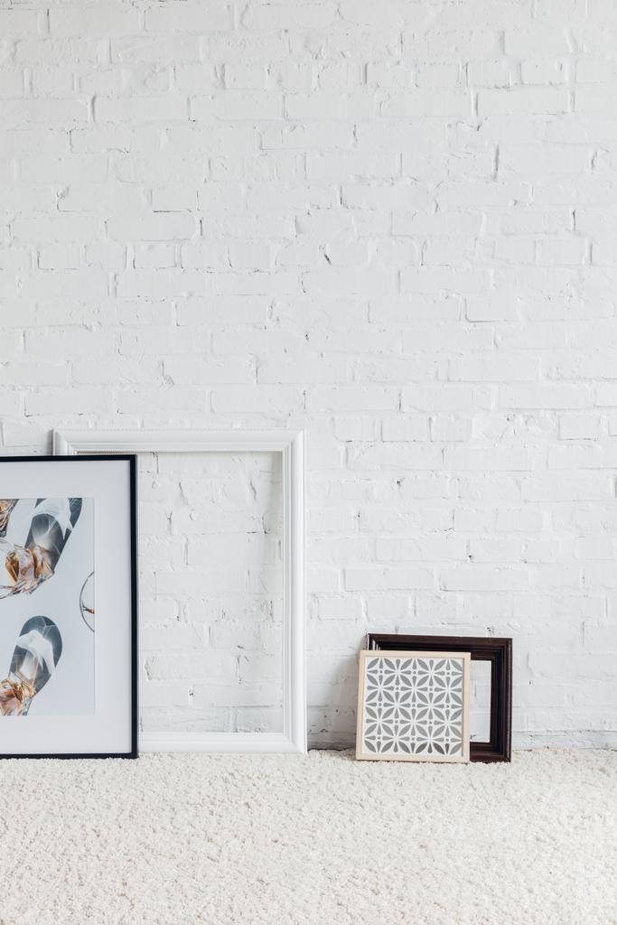 pictures in frames leaning on white brick wall, mockup concept - Photo, Image