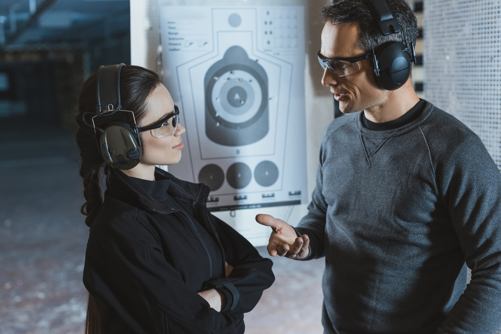 shooting instructor and client talking in shooting range - Photo, Image