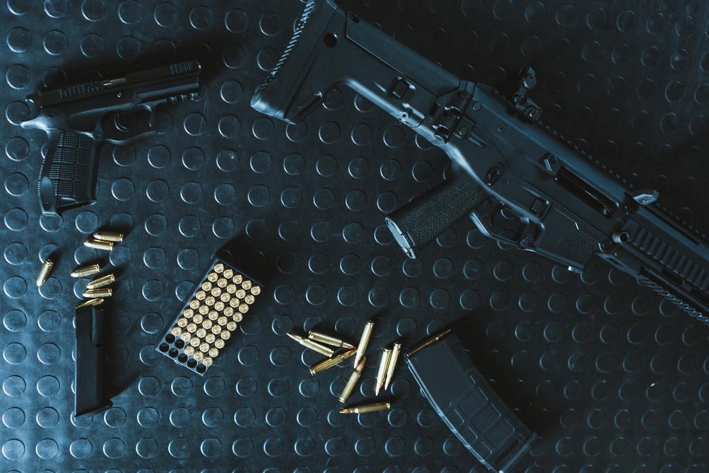 top view of gun and rifle with bullets on table - Photo, Image
