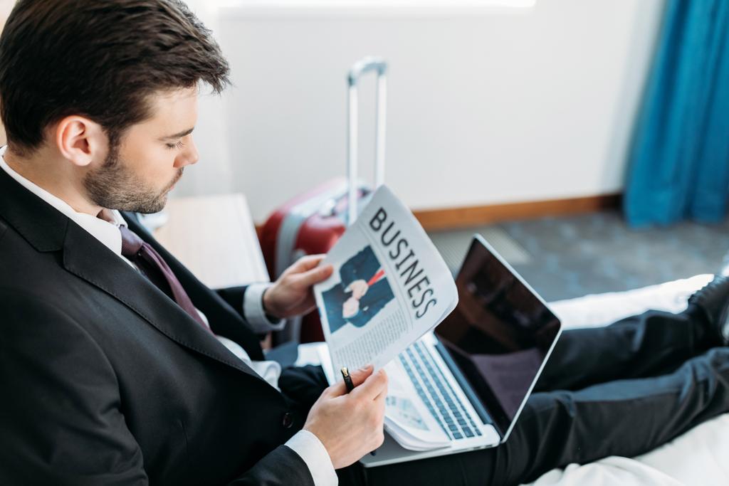 zakenman lezen van de krant in hotelkamer - Foto, afbeelding