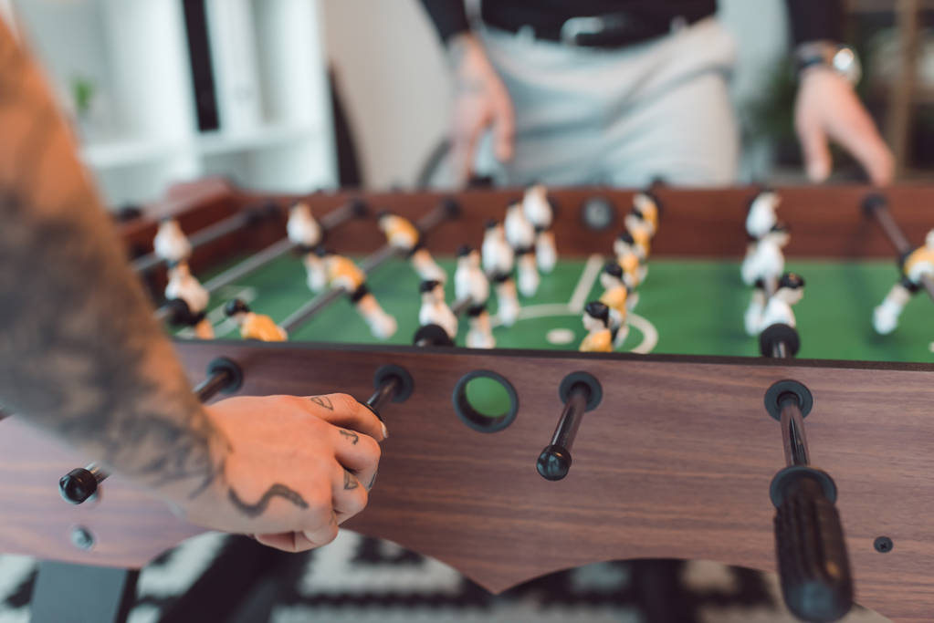 selective focus of colleagues playing table football in office - Photo, Image