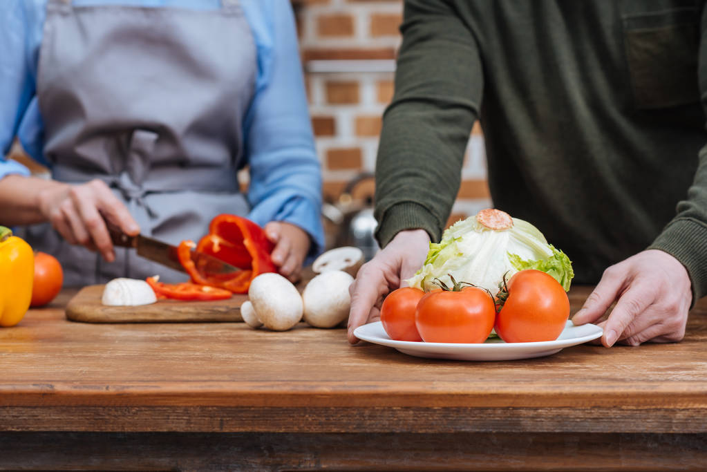 cropped image of couple preparing vegetables - Photo, Image