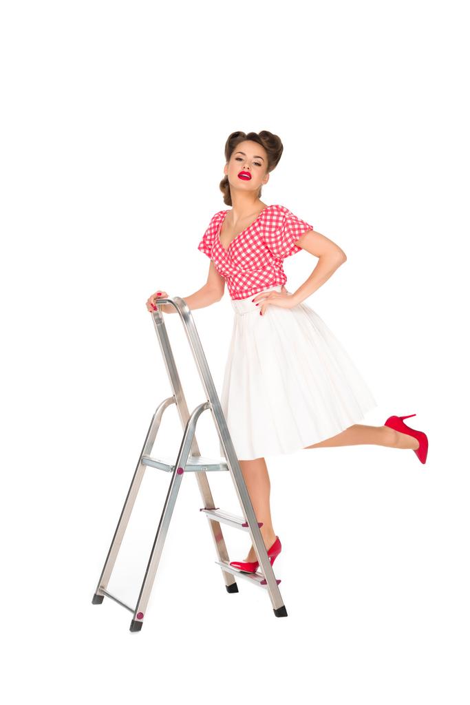 pin up woman standing on ladder isolated on white - Photo, Image
