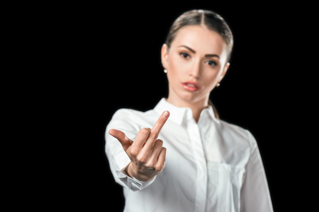 selective focus of woman showing middle finger, isolated on black - Photo, Image