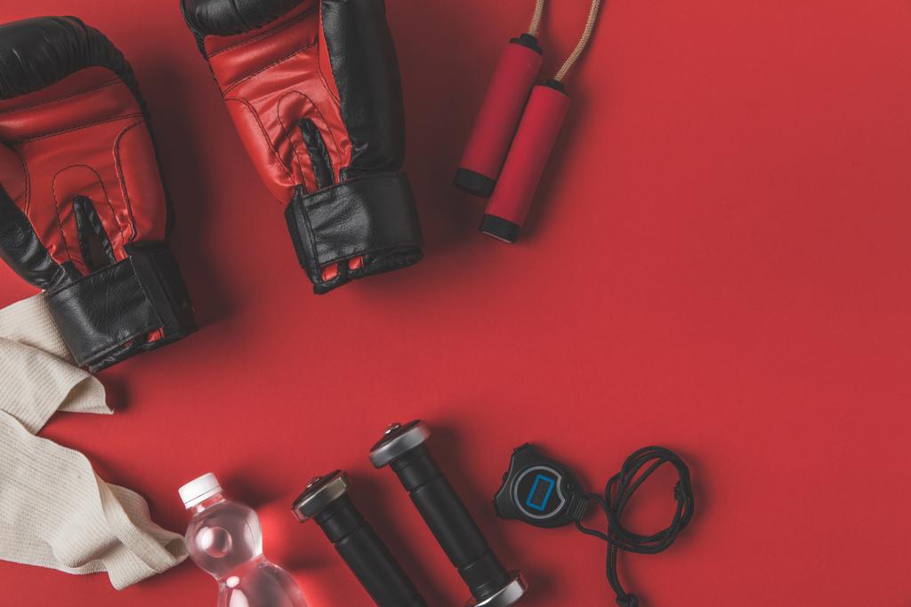 flat lay composition of boxer training equipment on red tabletop - Photo, Image