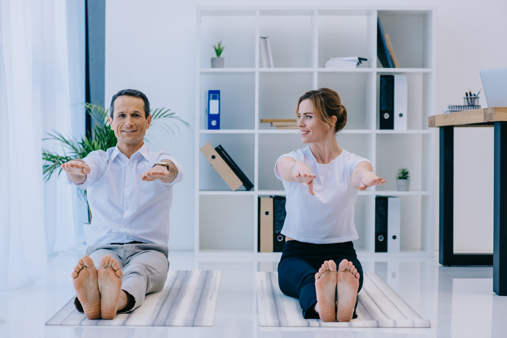 homme d'affaires avec son entraîneur pratiquant le yoga à Dandasana pose au bureau
 - Photo, image