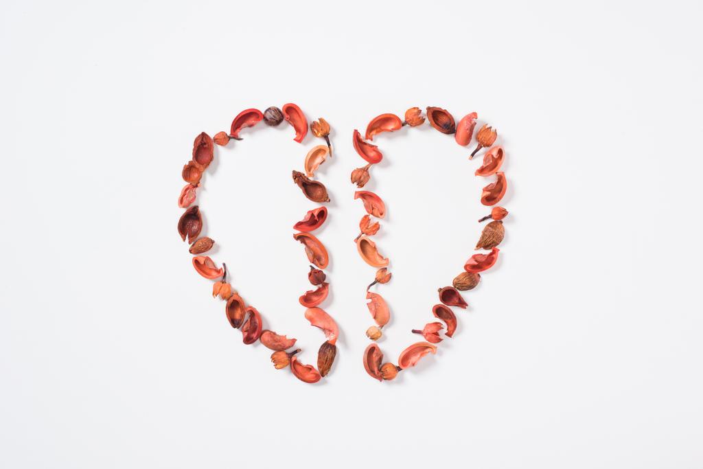 top view of two halves of heart from dried fruits isolated on white, valentines day concept - Photo, Image