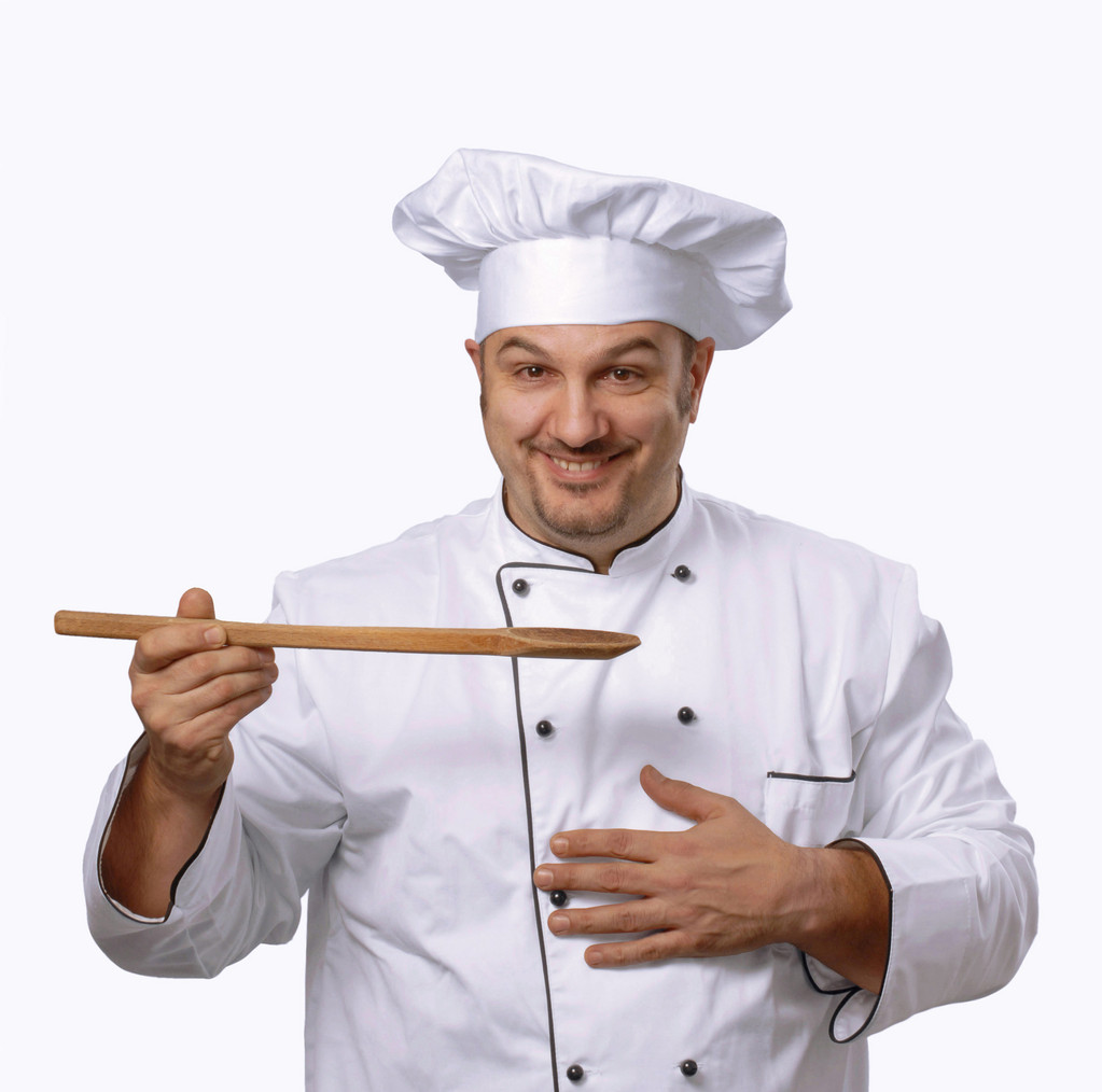 koken houdt een houten spoon.chef met een houten lepel. - Foto, afbeelding