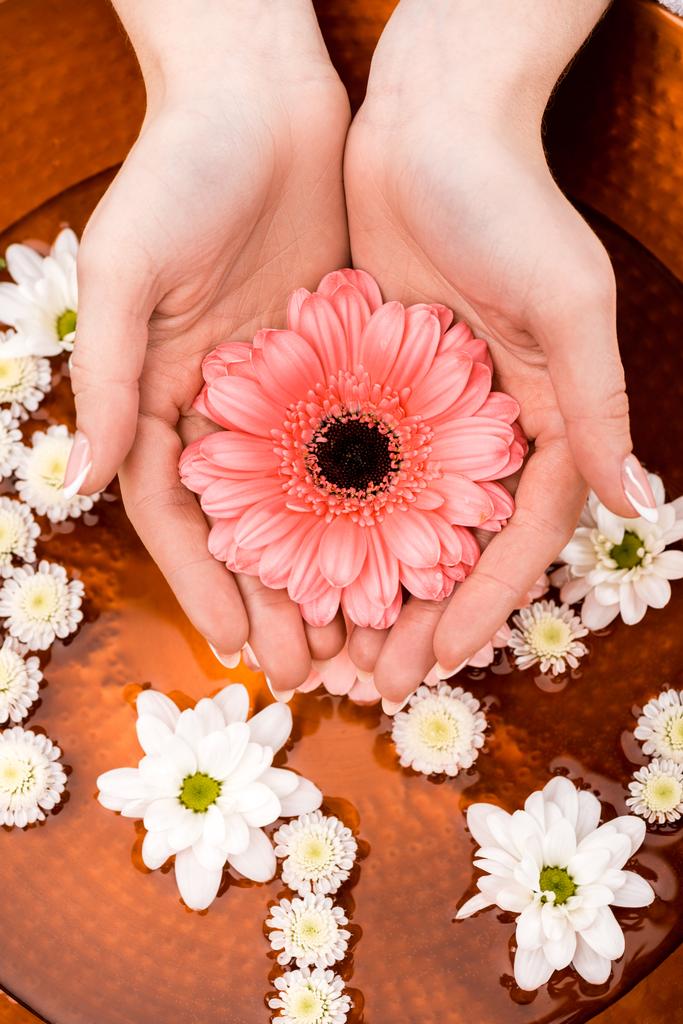 cropped view of woman making spa procedure with flowers in beauty salon, nail care concept - Photo, Image