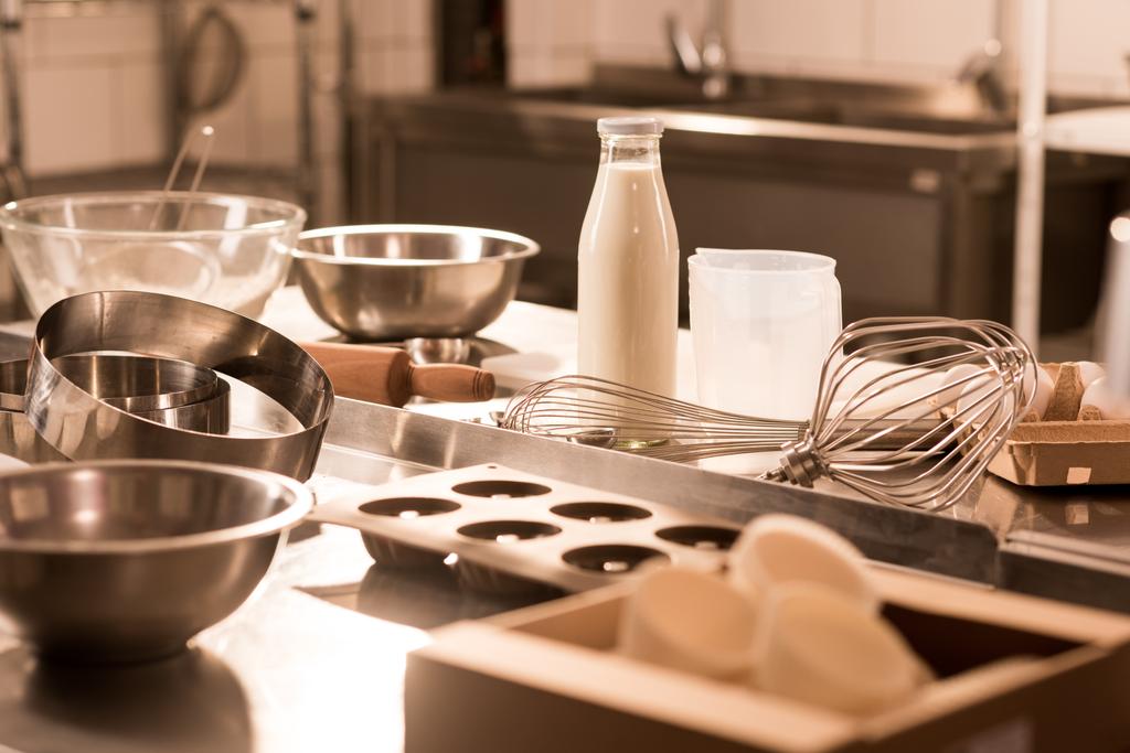 close up view of ingredients for dough and kitchen utensils on counter in restaurant - Photo, Image