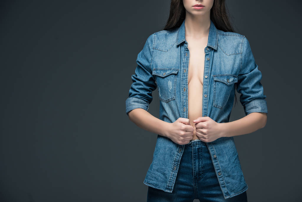 cropped view of woman posing in trendy denim clothes, isolated on grey  - Photo, Image