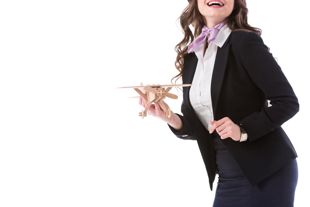immagine ritagliata della hostess sorridente che tiene il modello piano isolato su bianco
 - Foto, immagini