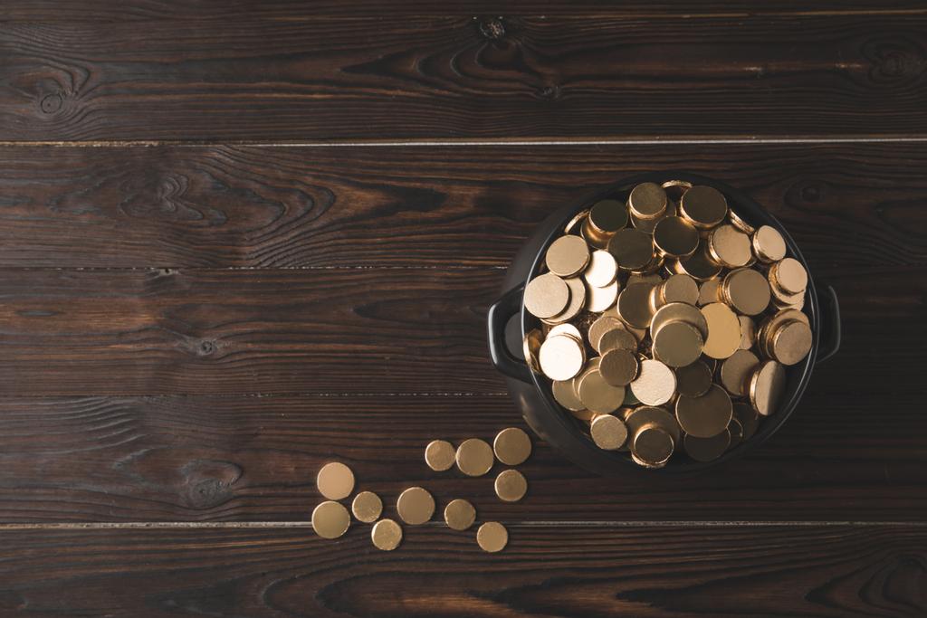 top view of pot of golden coins on wooden table, st patricks day concept - Photo, Image