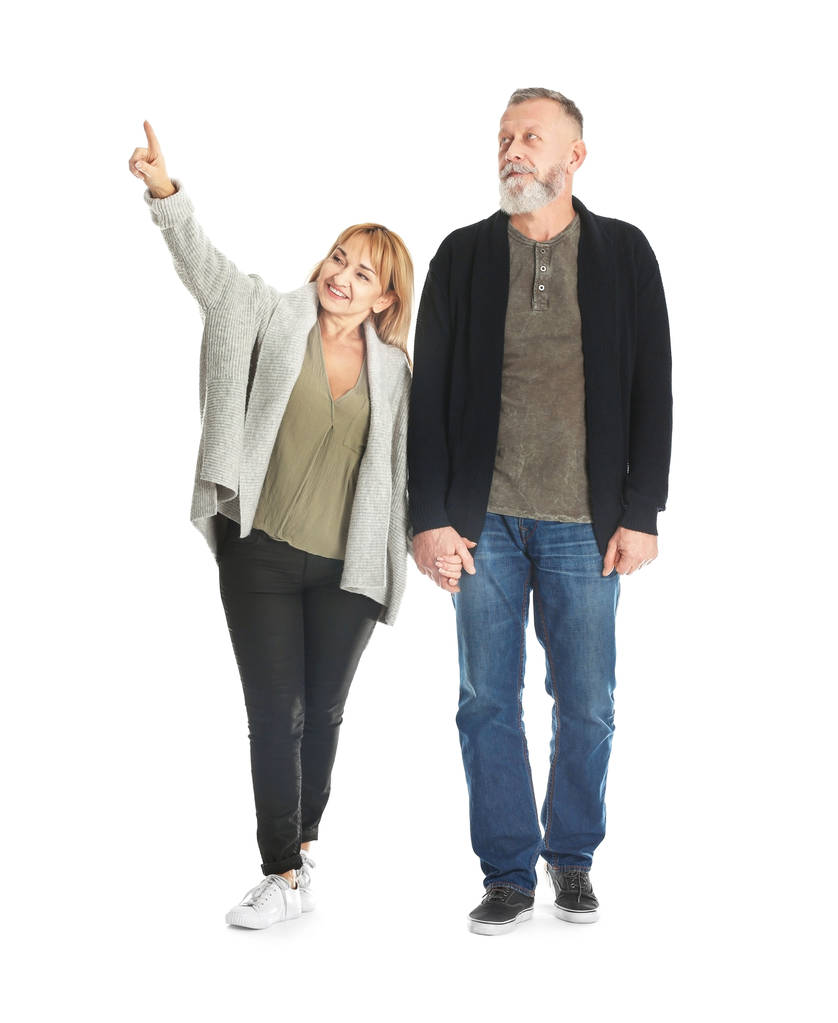 Mature couple in casual clothes walking on white background - Photo, Image