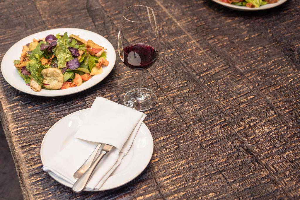 tasty salad with wine on rustic wooden table - Photo, Image