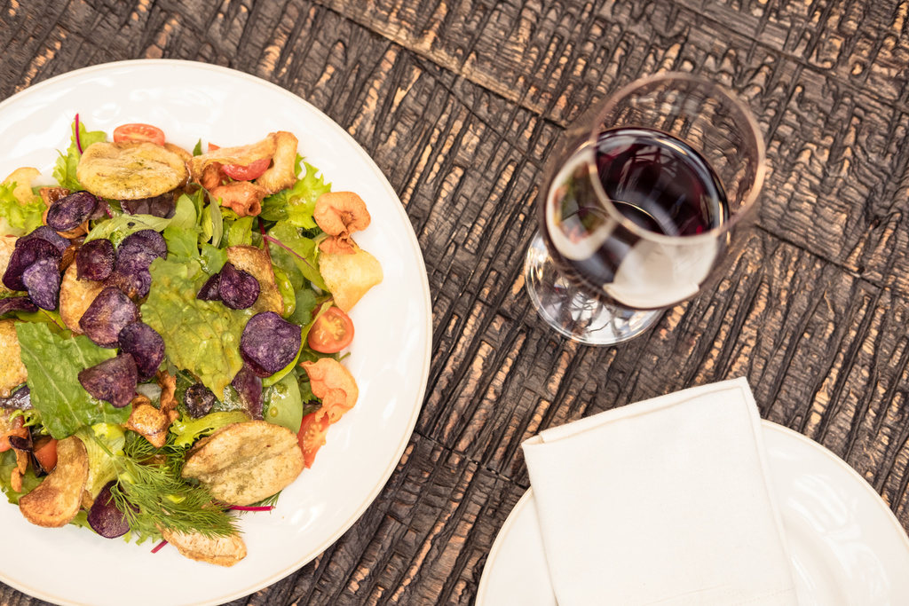 delicious salad with wine on rustic wooden table - Photo, Image