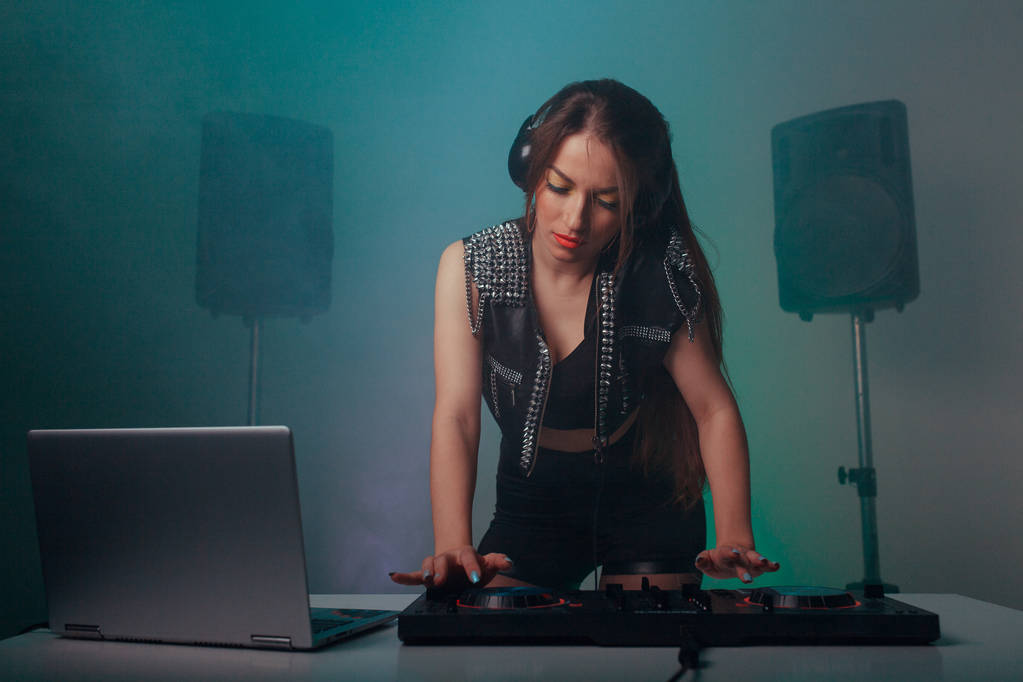 Beautiful brunette DJ playing music at a party - Photo, Image