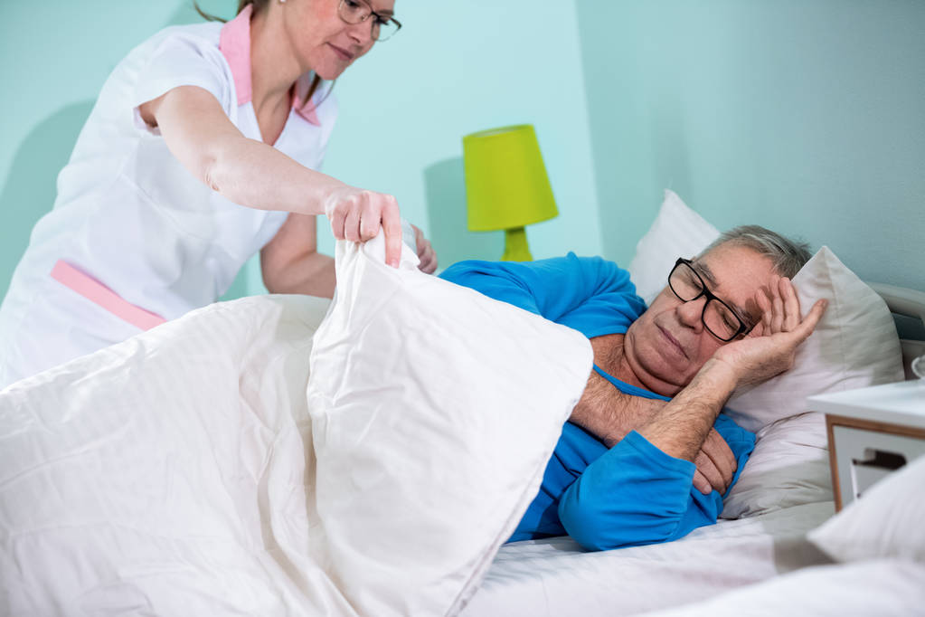 Медсестра піклується про пацієнта в будинку престарілих
 - Фото, зображення