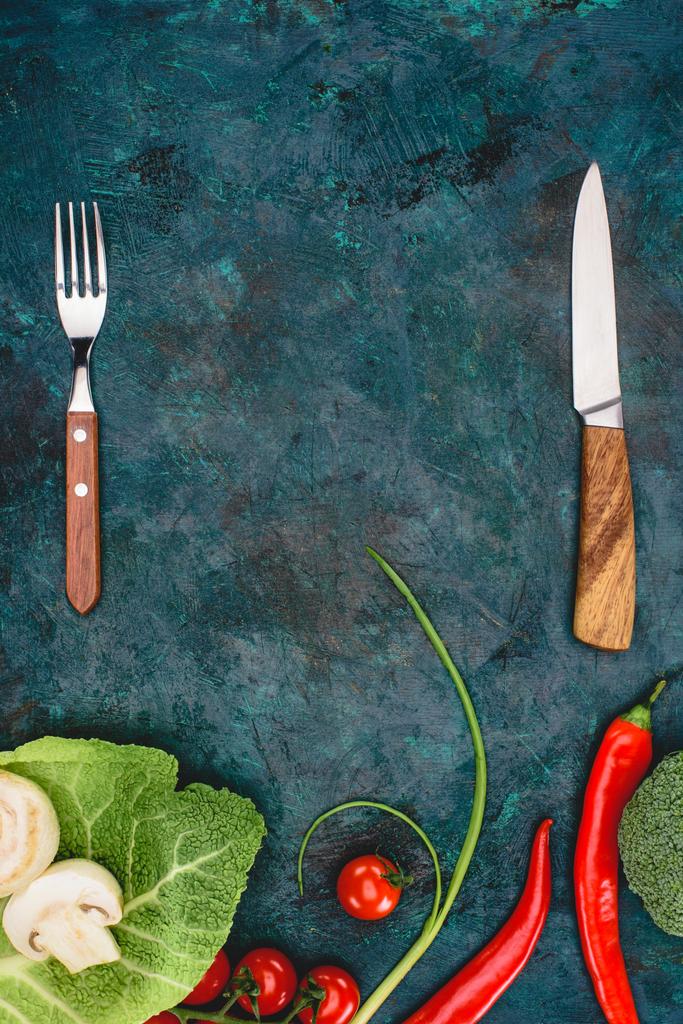 top view of fork with knife and fresh healthy vegetables on black - Photo, Image