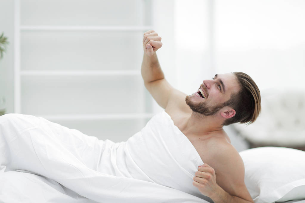 усміхнений чоловік прокидається вранці
 - Фото, зображення