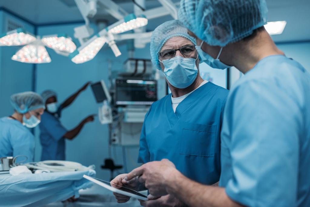 médicos usando tablet na sala de cirurgia
 - Foto, Imagem