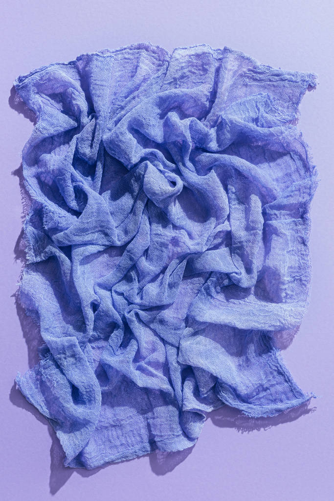 bovenaanzicht van paarse gaas weefsel op paarse backgroundtissue - Foto, afbeelding