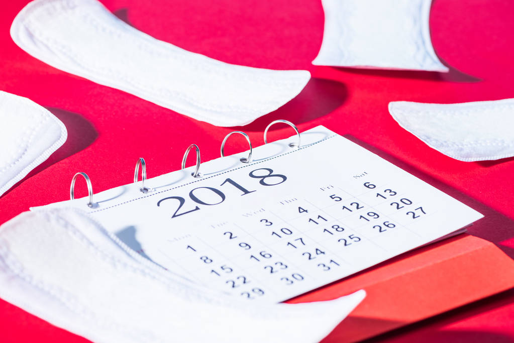 scattered daily liners and calendar on red - Photo, Image