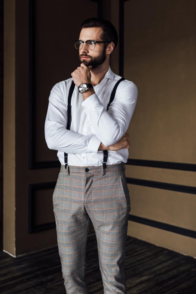 pensive fashionable man in trendy suspenders   - Photo, Image