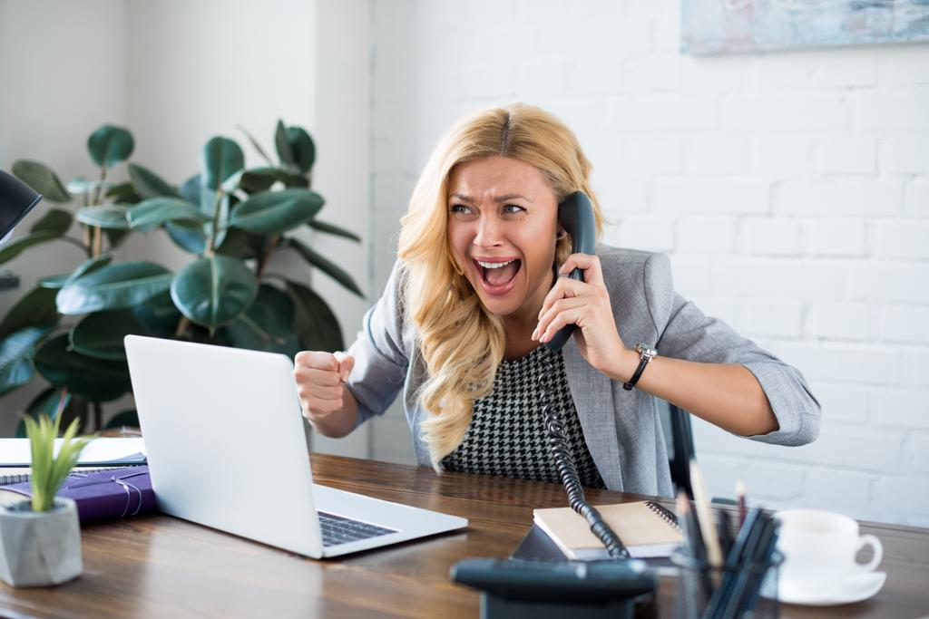 взволнованная деловая женщина разговаривает по телефону в офисе и показывает да жест
 - Фото, изображение