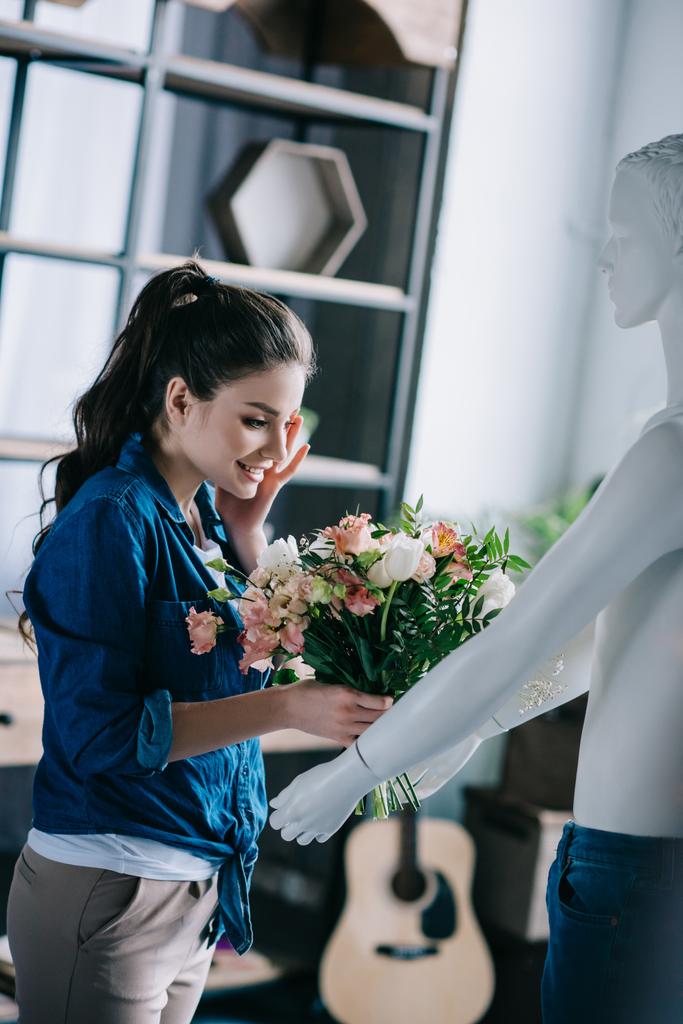 young woman pretending to receive flowers from layman doll, perfect relationship dream concept - Photo, Image