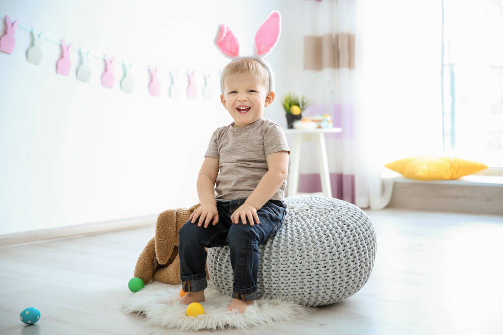 Cute little boy with bunny ears and Easter eggs indoors - Photo, Image