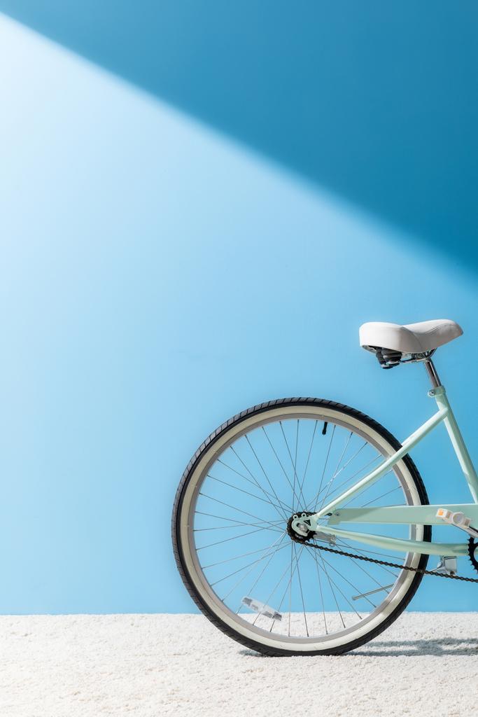 back wheel of bicycle in front of blue wall - Photo, Image