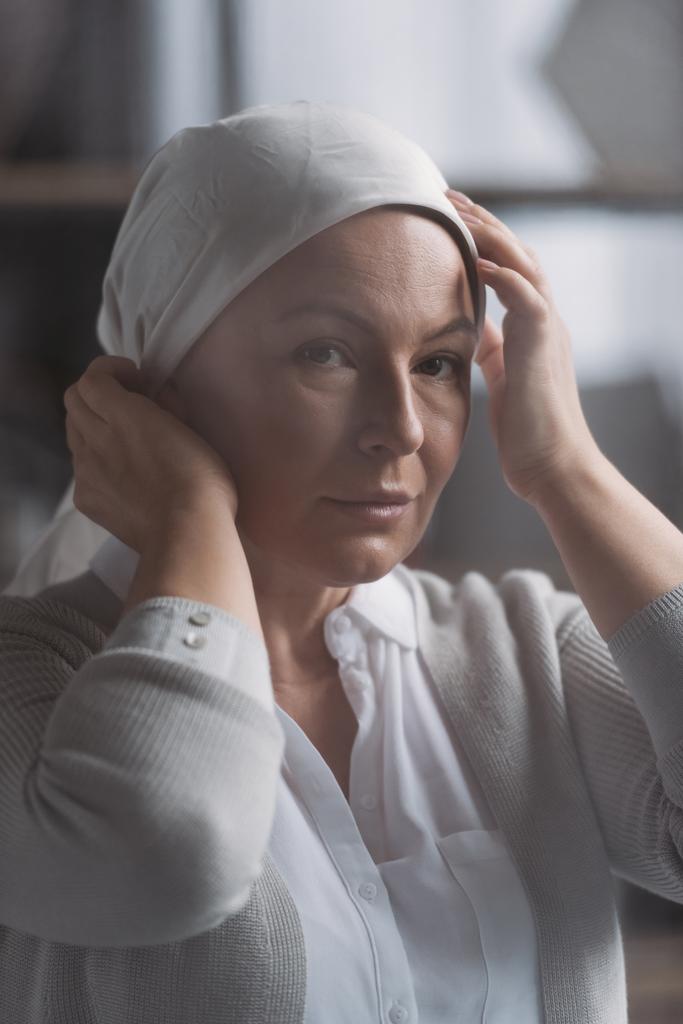 close-up view of sick mature woman in kerchief looking at camera - Photo, Image